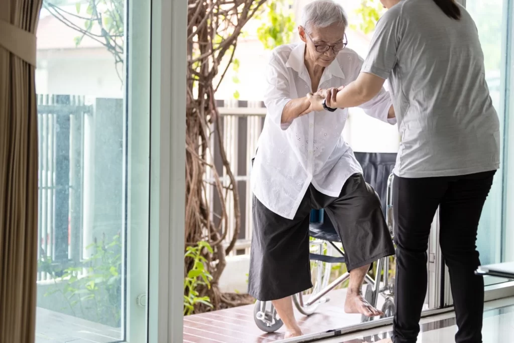 old woman getting helped